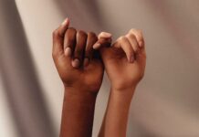 Berpegang Pada Perintah Tuhan persons hand with white manicure