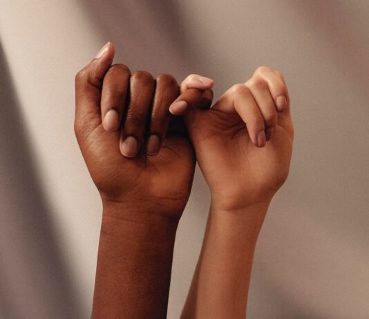 Berpegang Pada Perintah Tuhan persons hand with white manicure